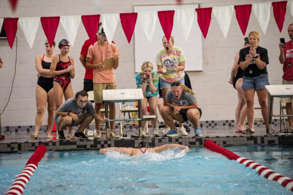 St. Johns swimmer approaches wall as fans cheer